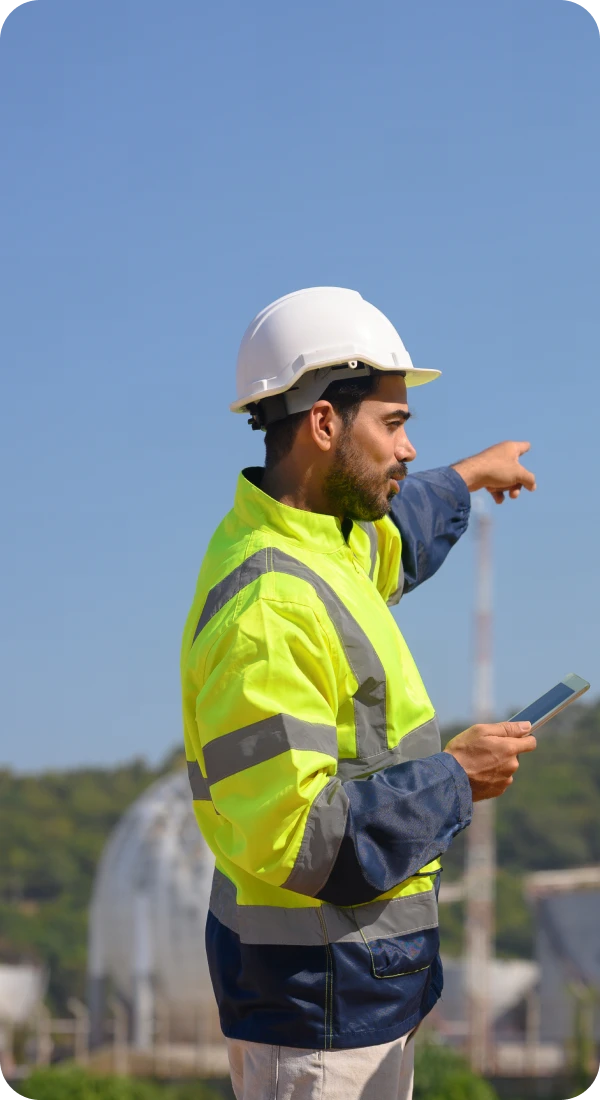 Construction worker pointing with tablet