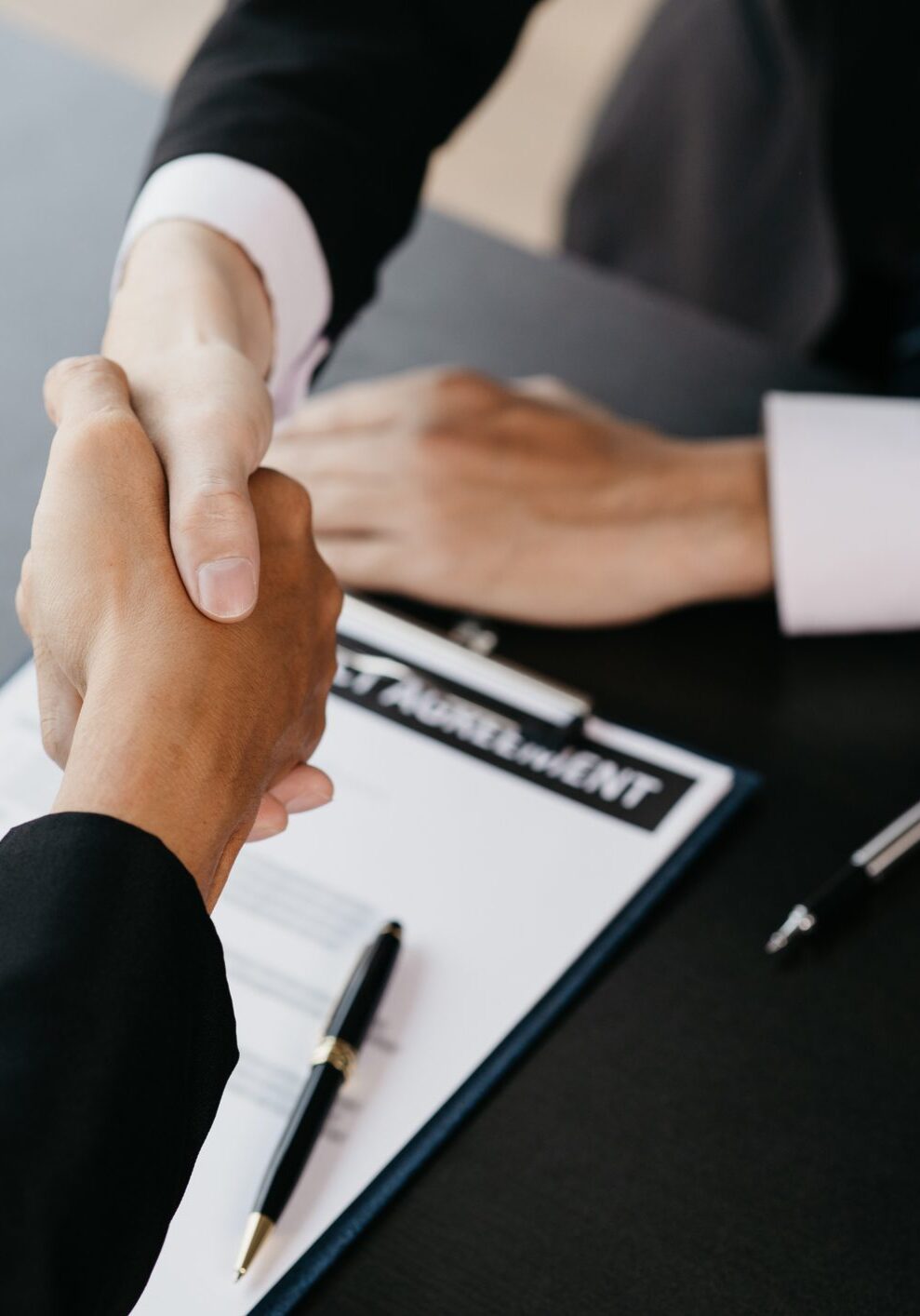 Lawyers shake hands with clients who come to testify in the case of embezzlement from business partners who jointly invest in the business. The concept of hiring a lawyer for legal proceedings.