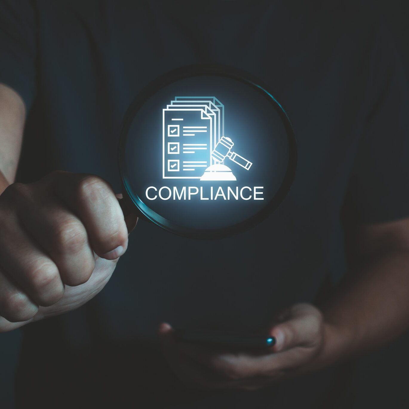 Compliance in business concept. Businessman magnifying glass with compliance icon on virtual screen, ensuring laws, regulations, and standards are enforced. Stay in line with business policies.