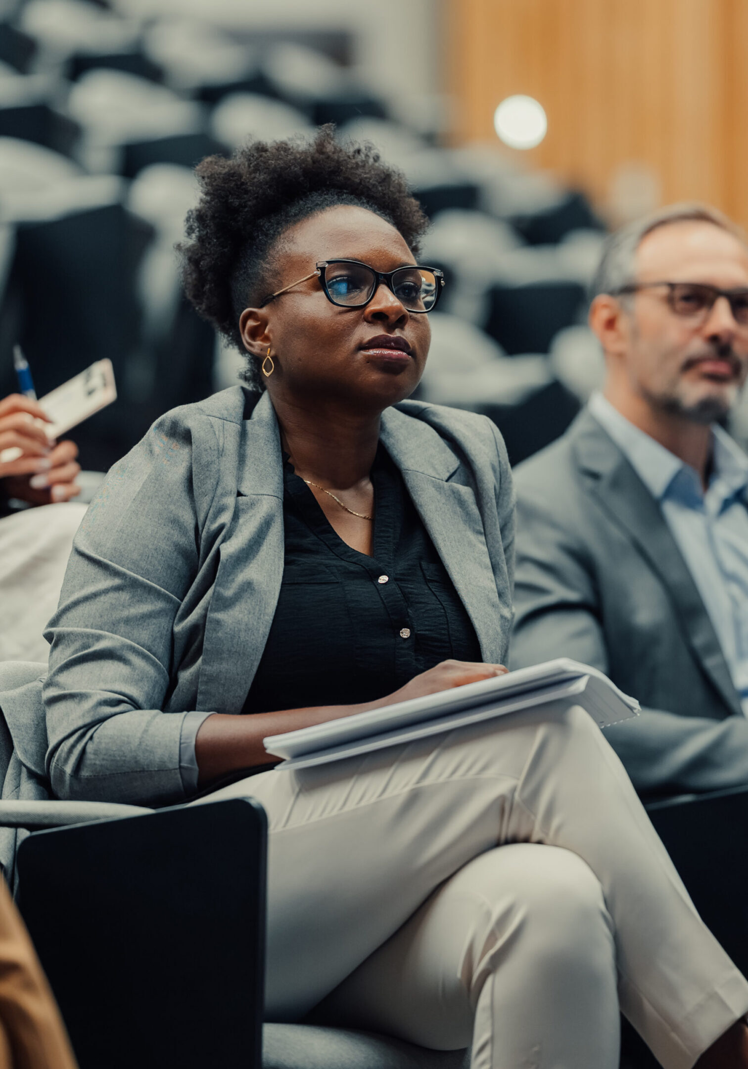 Diverse group of business people listening attentively and learning during a corporate seminar or education event