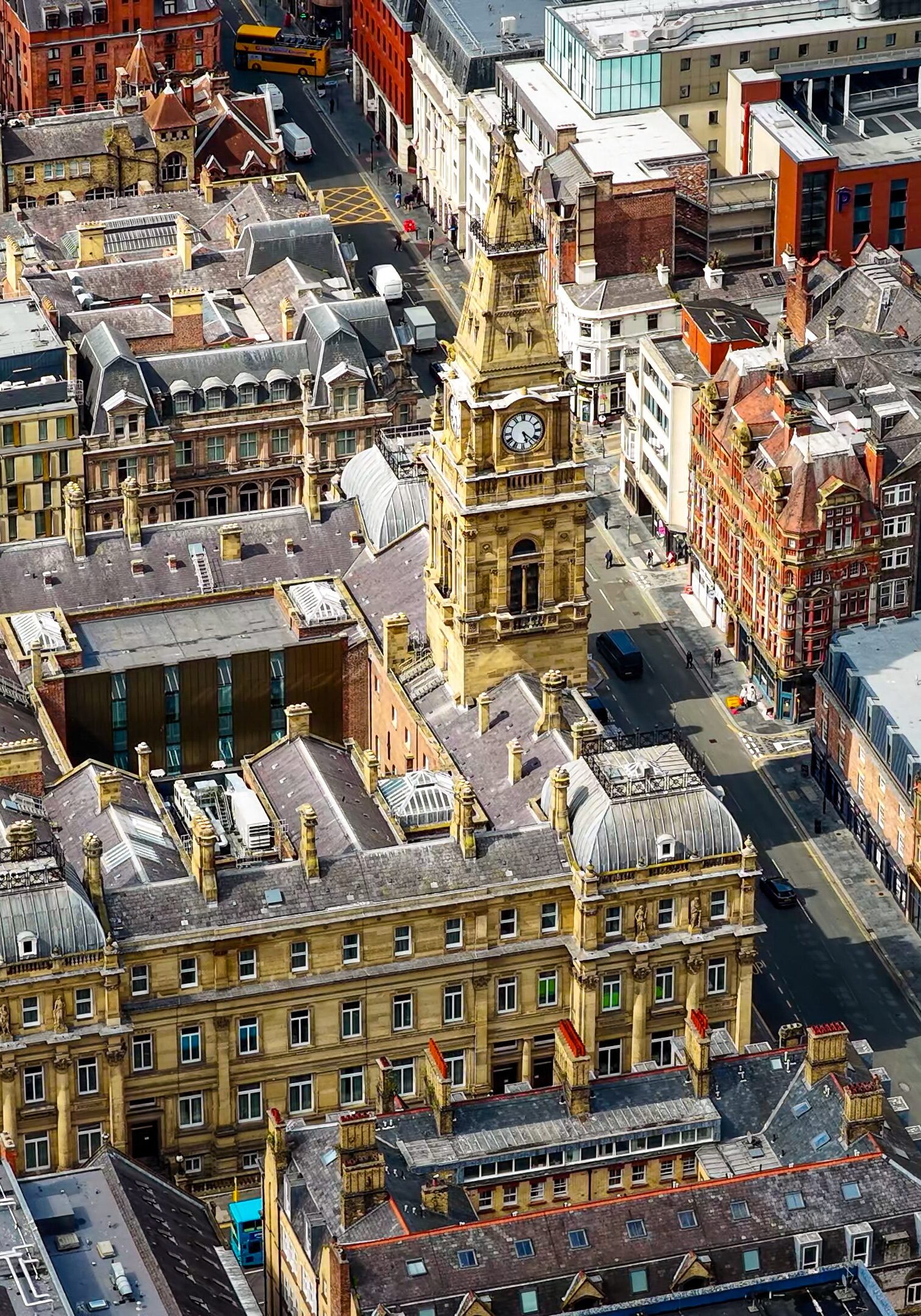 This aerial image shows the Liverpool Municipal Building located on Dale Street, featuring its prominent clock tower and ornate Victorian-era architecture. The surrounding streets are lined with historic buildings, commercial offices, and modern structures in the background, with the River Mersey visible further beyond. This view reflects Liverpool’s rich architectural heritage, blending history with contemporary urban development. The Municipal Building is a key civic landmark in the city, making this image suitable for themes such as government, history, architecture, tourism, real estate, and culture within Merseyside and the wider North West England region.